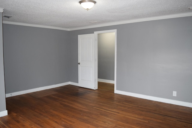 empty room with crown molding, a textured ceiling, dark wood-type flooring, and baseboards