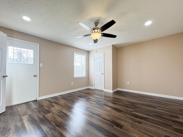 empty room featuring baseboards, dark wood finished floors, recessed lighting, a textured ceiling, and a ceiling fan