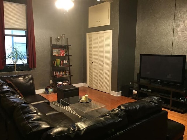 living room featuring baseboards and wood finished floors