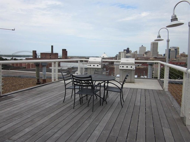 deck featuring a view of city and a grill