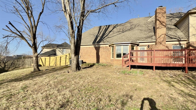 view of yard with a wooden deck and fence