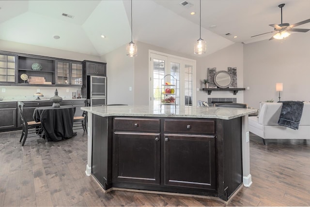 kitchen featuring visible vents, dark wood-type flooring, lofted ceiling, and open shelves