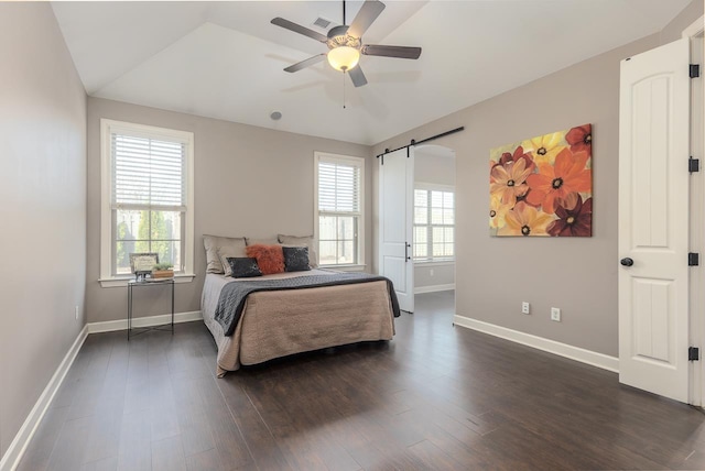 bedroom featuring dark wood finished floors, visible vents, baseboards, and ceiling fan