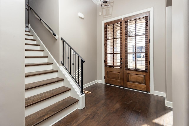 foyer entrance featuring hardwood / wood-style floors, stairway, french doors, and baseboards