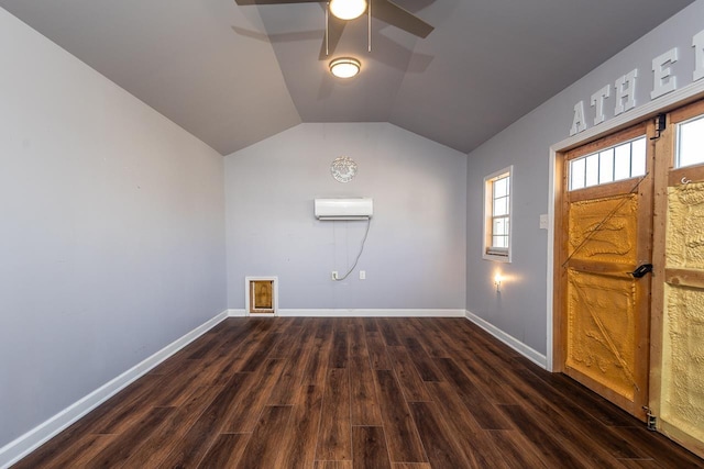 entryway with baseboards, ceiling fan, dark wood finished floors, vaulted ceiling, and a wall mounted AC