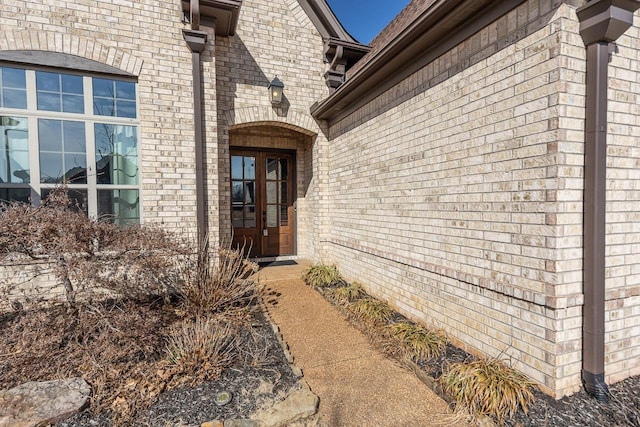 doorway to property with brick siding