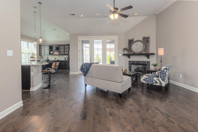 living room with a fireplace, baseboards, dark wood-type flooring, and ceiling fan