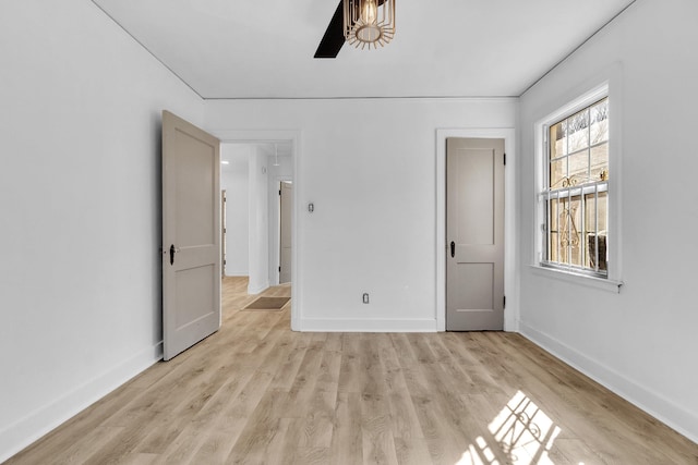 unfurnished room with baseboards and light wood-type flooring