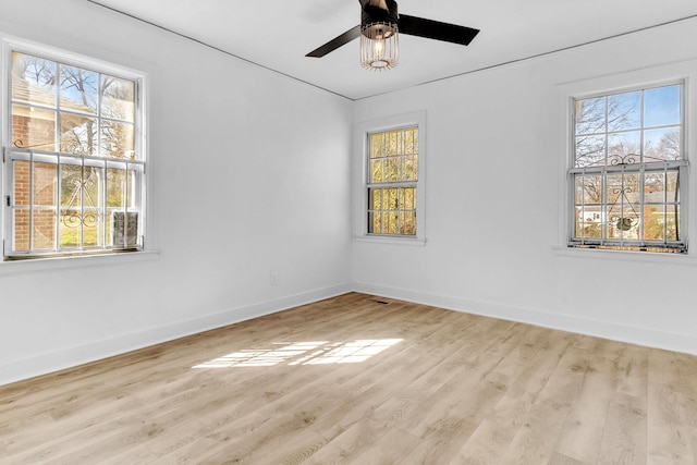 unfurnished room with wood finished floors, baseboards, and ceiling fan