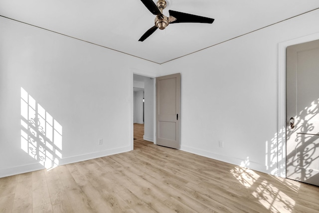 unfurnished living room with wood finished floors, baseboards, and ceiling fan