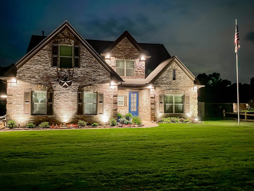 craftsman house featuring a lawn and stone siding