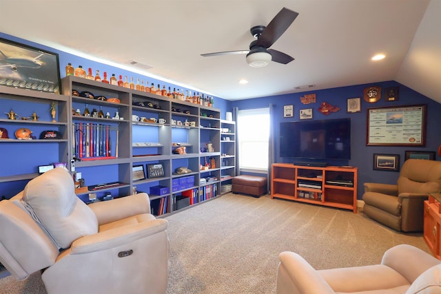 living room featuring visible vents, a ceiling fan, carpet, and vaulted ceiling