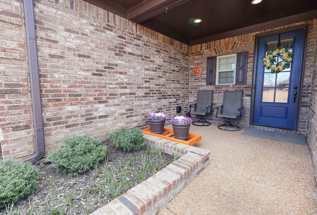 property entrance featuring brick siding