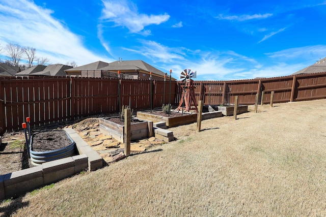 view of yard with a garden and fence