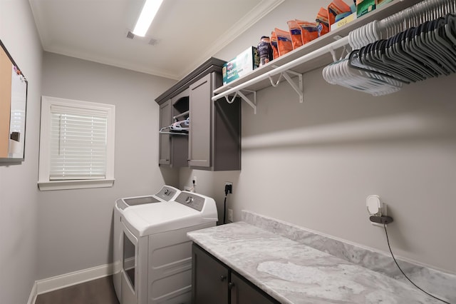 clothes washing area featuring baseboards, cabinet space, independent washer and dryer, and ornamental molding