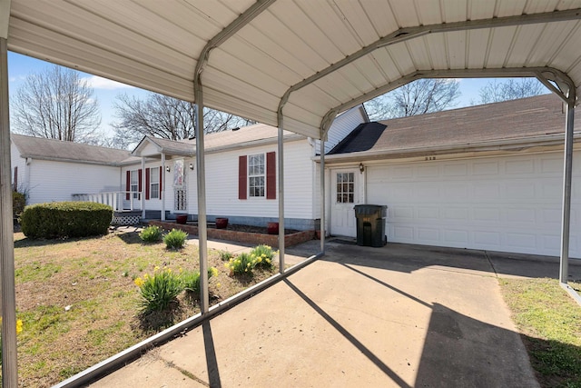 exterior space featuring a carport, a garage, driveway, and a shingled roof