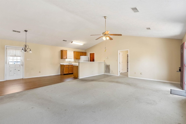 unfurnished living room featuring visible vents, light colored carpet, and a ceiling fan