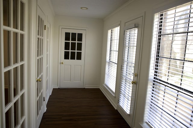 doorway with dark wood-style floors, french doors, baseboards, and ornamental molding