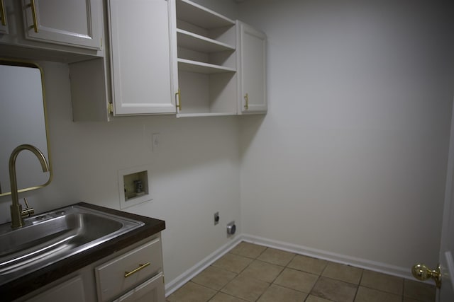 laundry area featuring washer hookup, a sink, cabinet space, light tile patterned floors, and hookup for an electric dryer