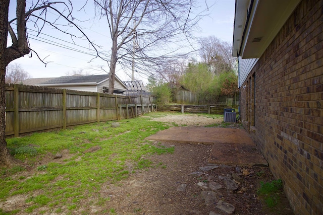 view of yard with cooling unit and a fenced backyard