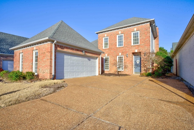 view of front of house featuring concrete driveway, an attached garage, brick siding, and roof with shingles