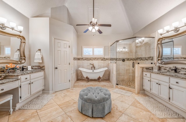 full bath with a shower stall, vaulted ceiling, a textured ceiling, a ceiling fan, and a sink