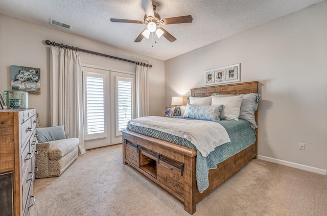 bedroom with light carpet, visible vents, a textured ceiling, and access to outside