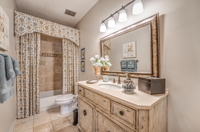 bathroom with visible vents, toilet, vanity, tile patterned floors, and a textured ceiling