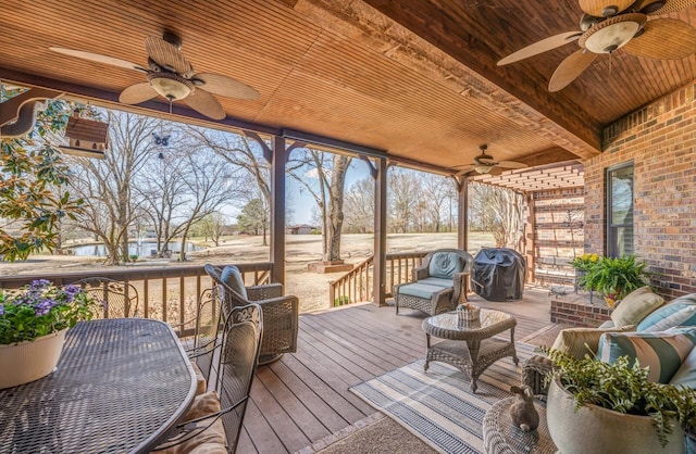 wooden deck with an outdoor living space, a ceiling fan, and a grill