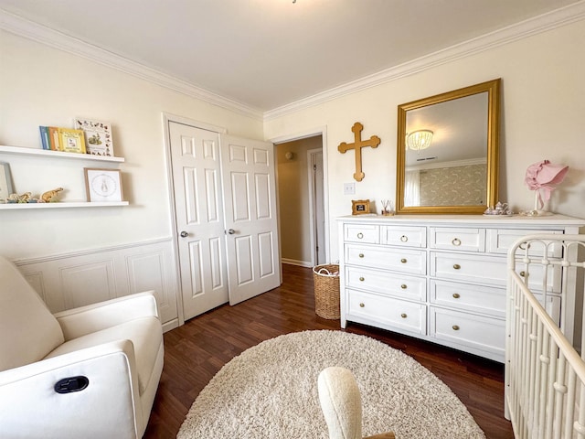 bedroom featuring a closet, dark wood finished floors, and ornamental molding