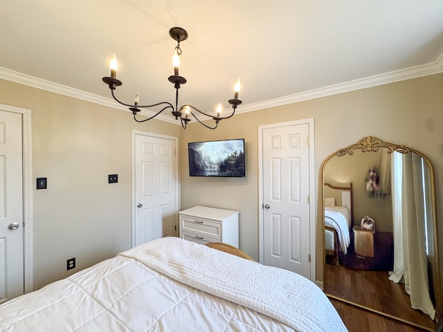 bedroom with ornamental molding, wood finished floors, and a chandelier