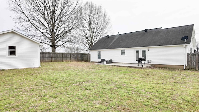 view of yard featuring a patio, french doors, and a fenced backyard