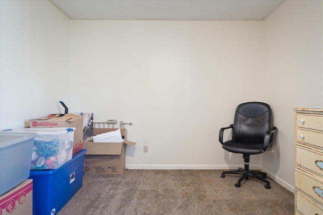 carpeted office featuring baseboards