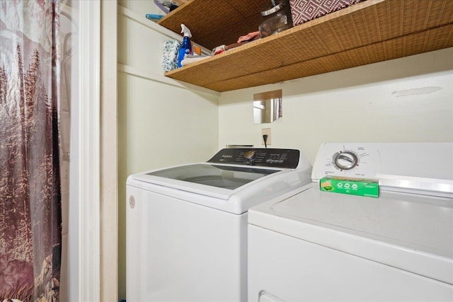 clothes washing area with laundry area and separate washer and dryer