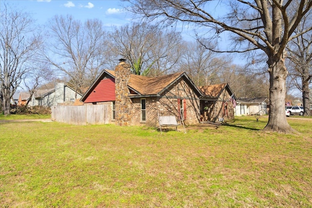 view of home's exterior with a lawn and a chimney