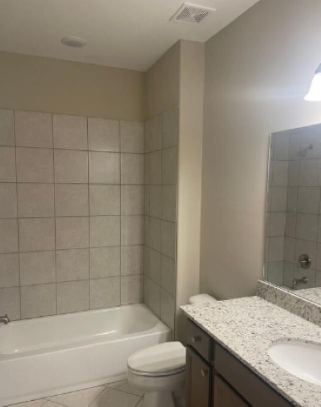 7718 Parkridge Dr, Southaven, MS 38671 - full bath with visible vents, toilet, shower / bath combination, vanity, and tile patterned flooring