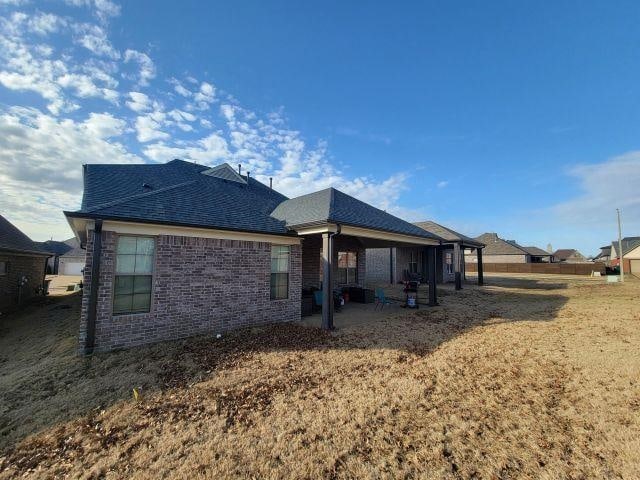 7718 Parkridge Dr, Southaven, MS 38671 - back of house featuring a patio area, brick siding, and a shingled roof