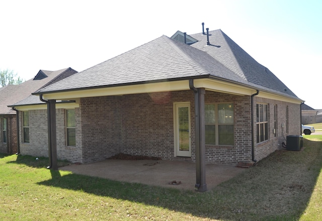 7718 Parkridge Dr, Southaven, MS 38671 - rear view of house with central AC unit, brick siding, a patio, and a lawn