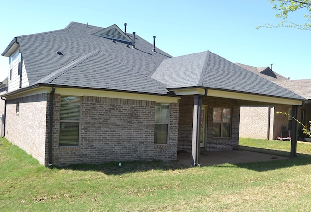 7718 Parkridge Dr, Southaven, MS 38671 - rear view of property featuring a patio area, a shingled roof, brick siding, and a lawn