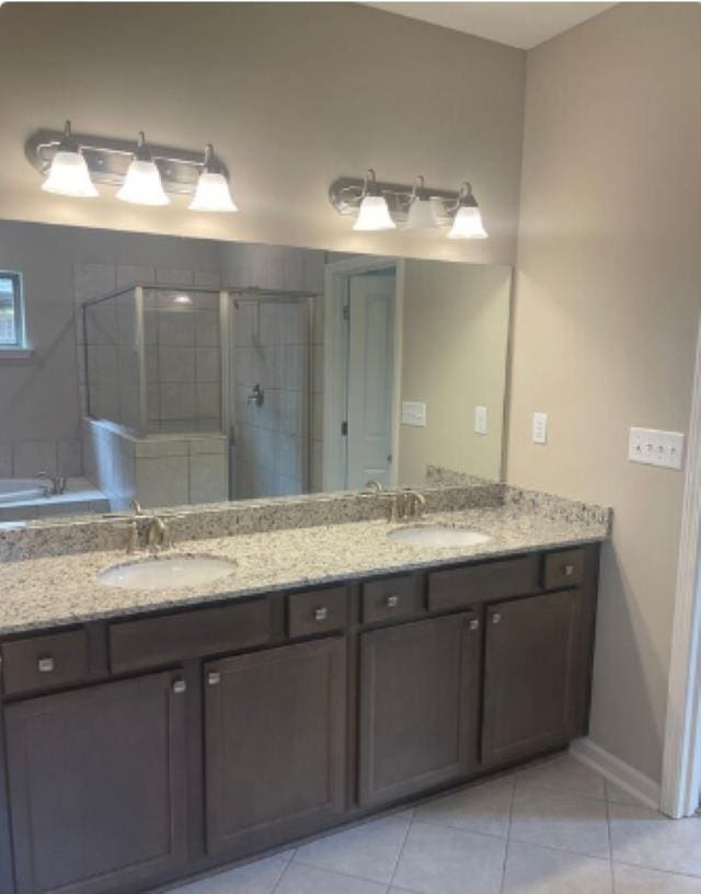 7718 Parkridge Dr, Southaven, MS 38671 - bathroom featuring a sink, a tile shower, double vanity, and tile patterned flooring
