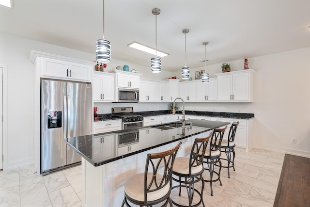kitchen featuring a sink, white cabinets, marble finish floor, and stainless steel appliances