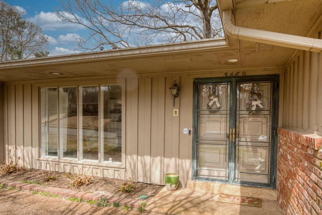 doorway to property featuring board and batten siding