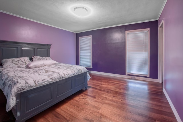 bedroom with baseboards, wood finished floors, and ornamental molding