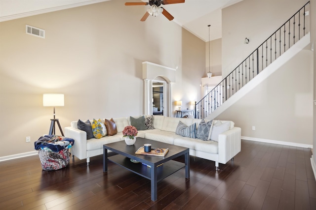 living area featuring baseboards, visible vents, ceiling fan, stairs, and dark wood-type flooring