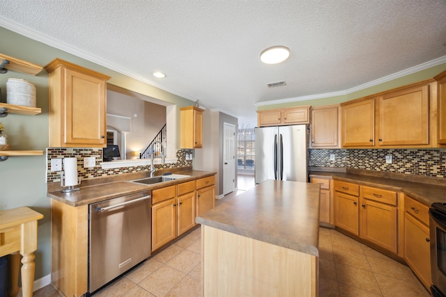 kitchen with visible vents, a sink, dark countertops, appliances with stainless steel finishes, and light tile patterned floors