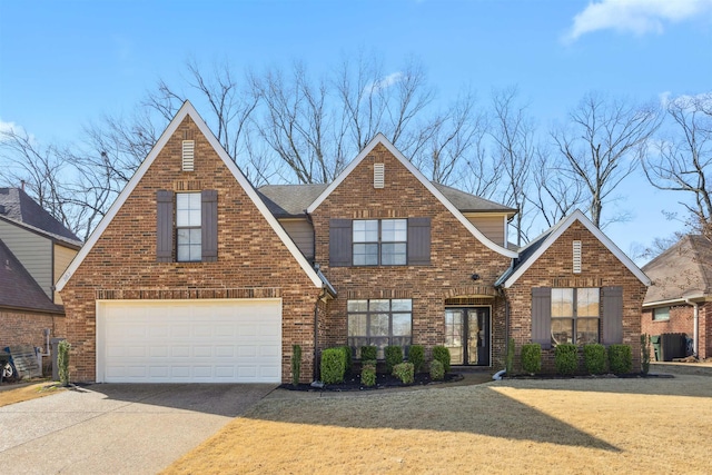 traditional-style home featuring central AC unit, driveway, a front lawn, a garage, and brick siding