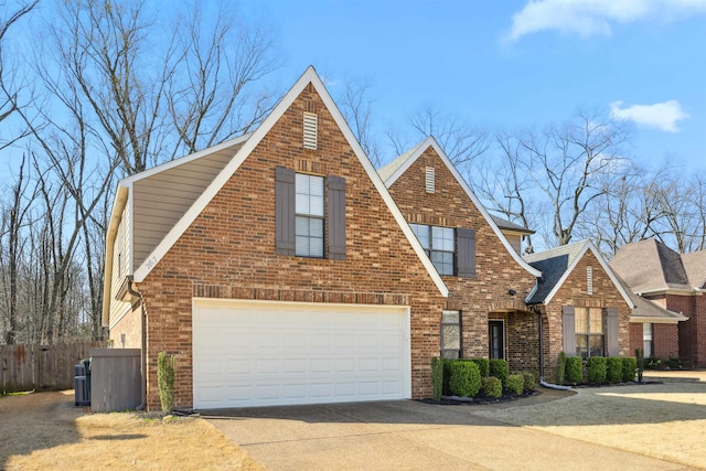 view of front of home featuring cooling unit, fence, concrete driveway, a garage, and brick siding