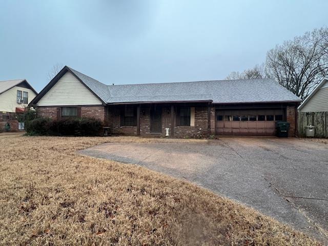 ranch-style house featuring driveway and a garage