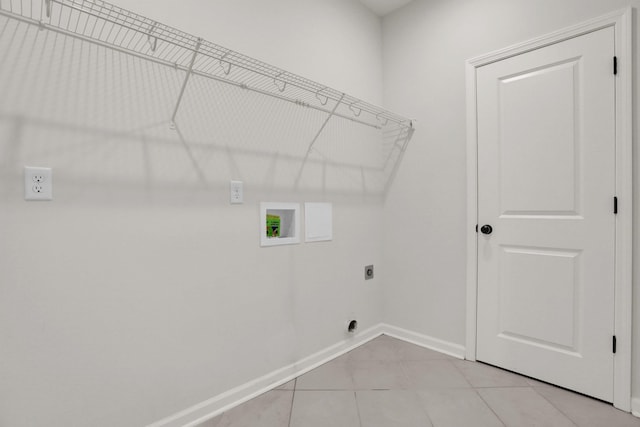 washroom featuring baseboards, laundry area, light tile patterned flooring, electric dryer hookup, and washer hookup