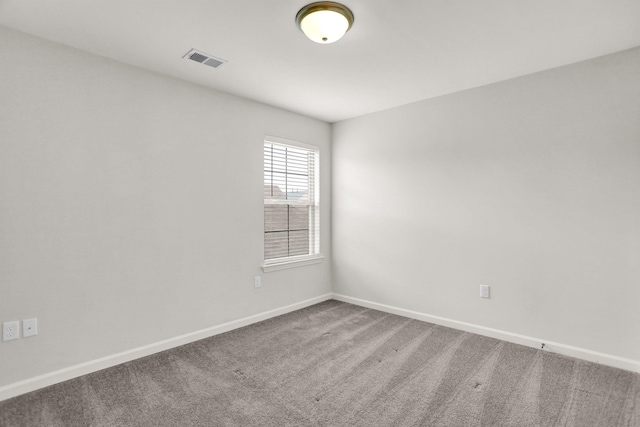 spare room featuring visible vents, baseboards, and carpet